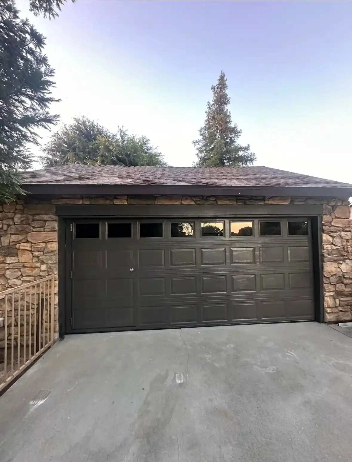 Dark brown two-car garage door with window row