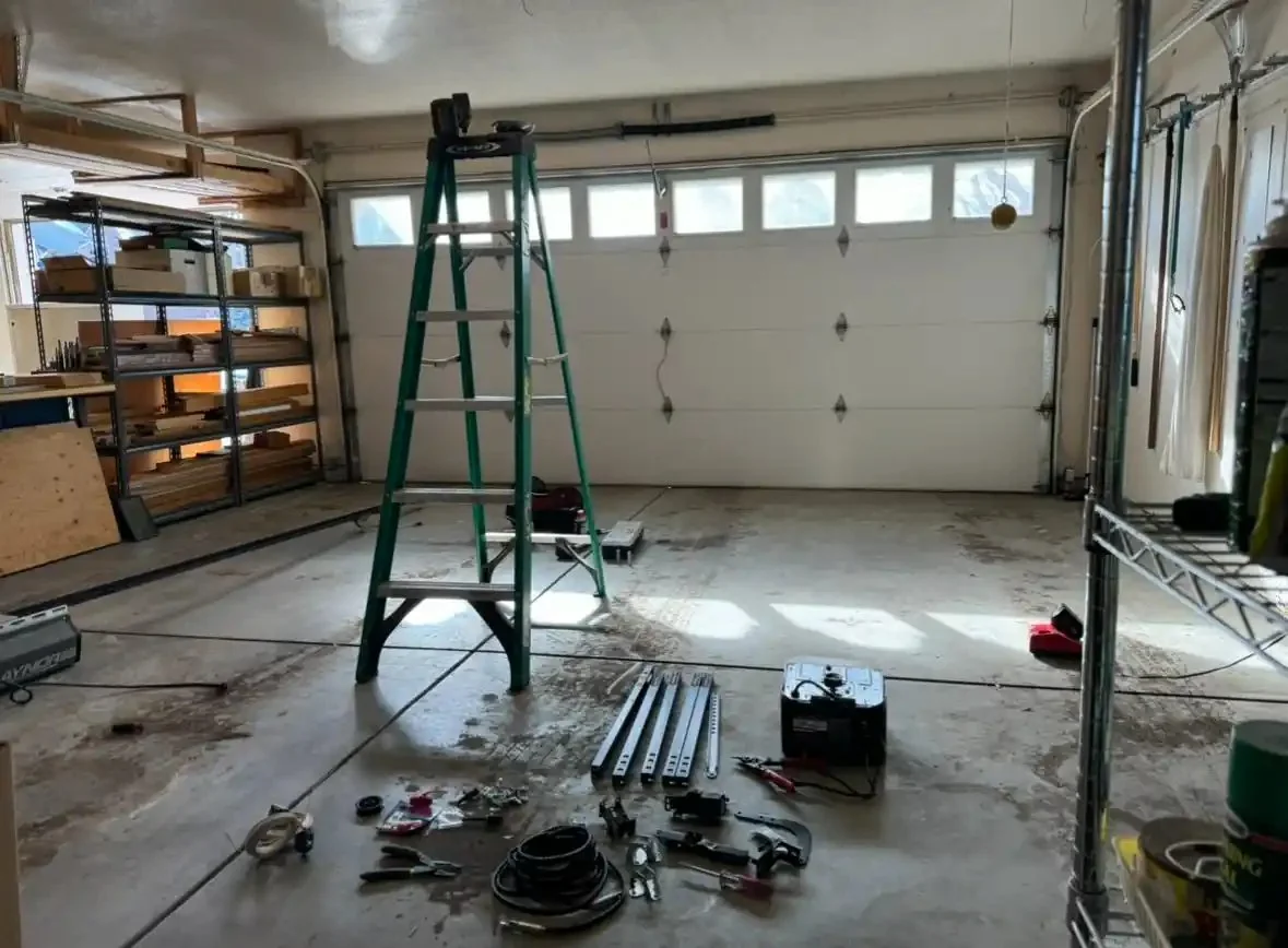 Technician installing a new garage door roller into the track