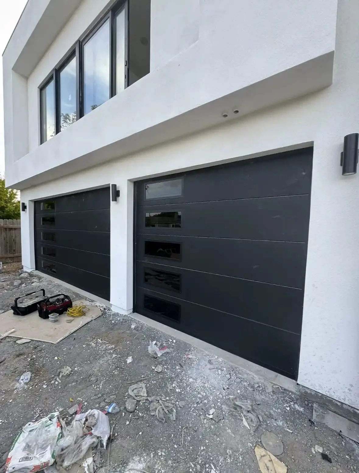 New black flush-panel garage doors on a new build