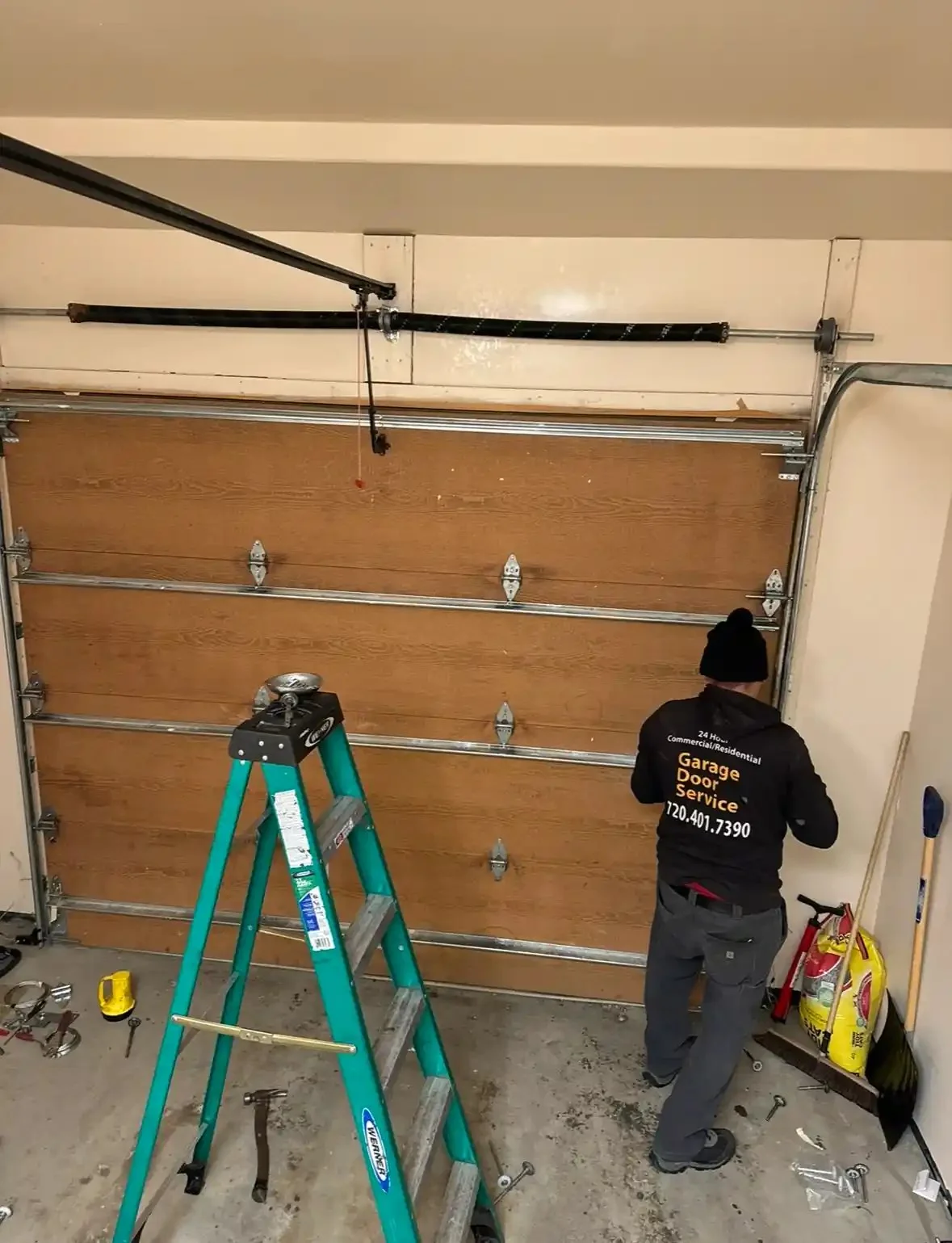Union technician repairing a wood-look garage door