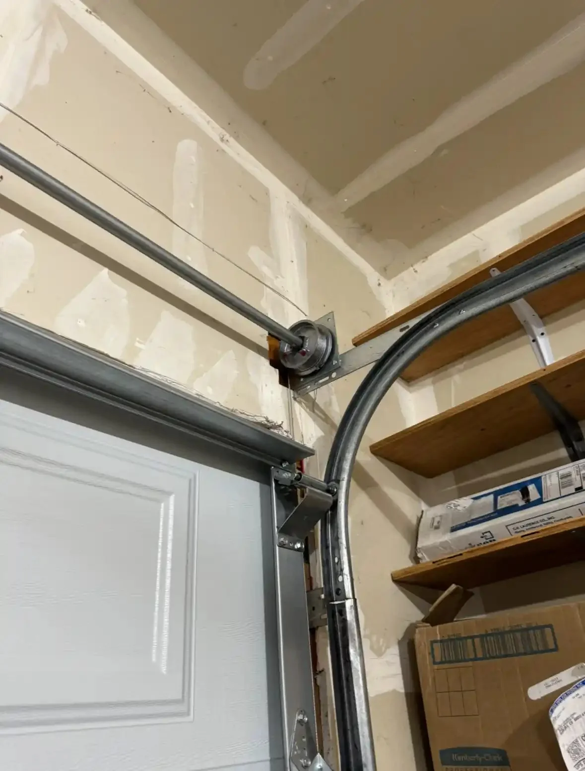 Torsion spring and track above a garage door
